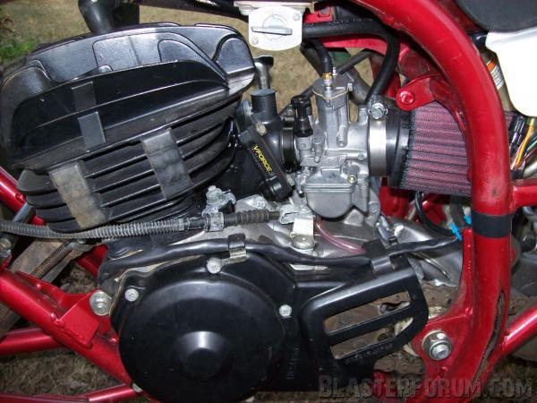 2005's engine. Stock internals, with a Toomey B-1 pipe kit, 28mm Keihin PWK carb, VF3 reeds, K&N pod air filter, TORS surgery, oil injection block-off, and Extreme Billet side cover (not shown here). Looks like I forgot the air filter Outerwear in this pic. CFM airbox coming soon...